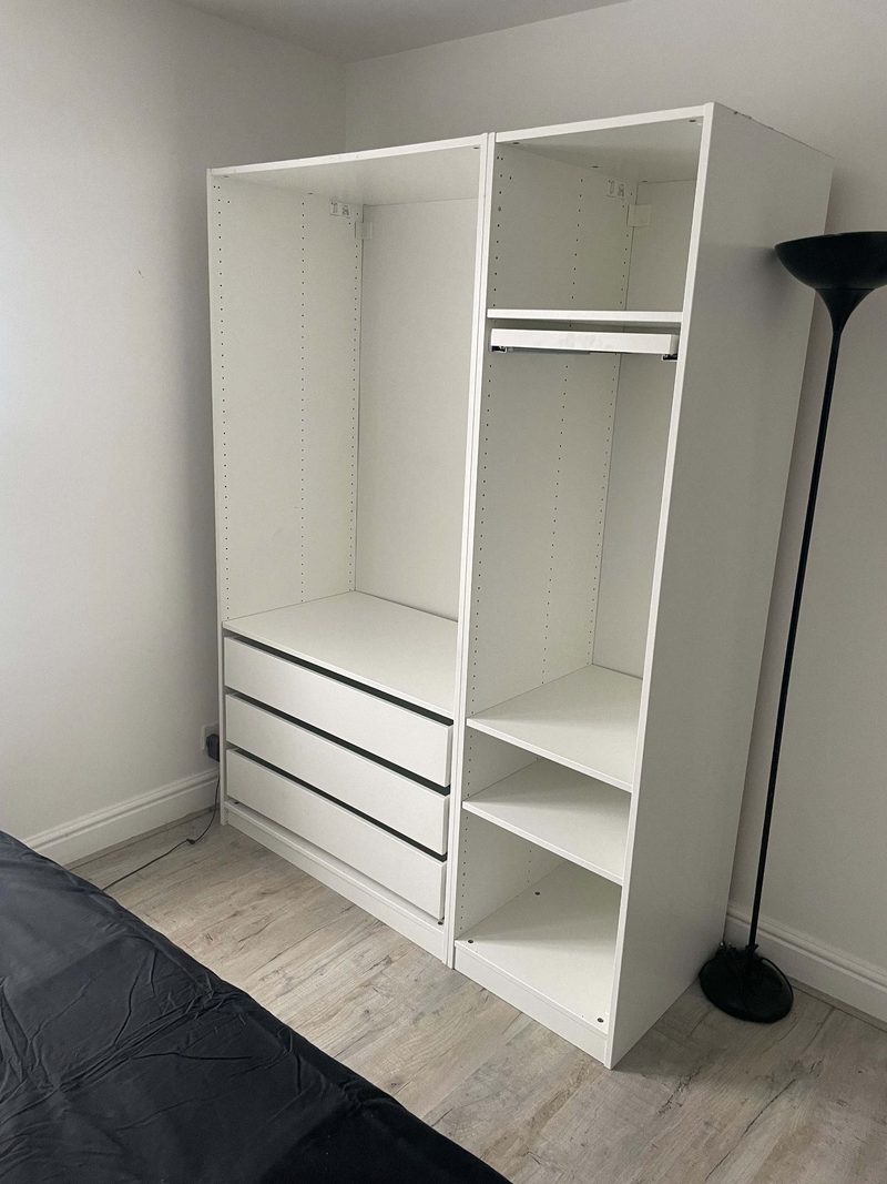 Assembled IKEA Pax wardrobe units with internal shelving and drawers