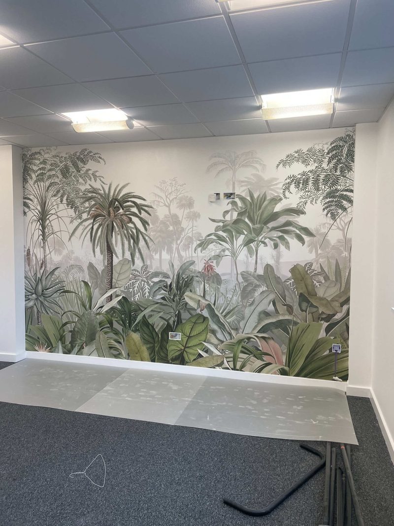 Botanical jungle wallpaper mural hung on a feature wall in a London office