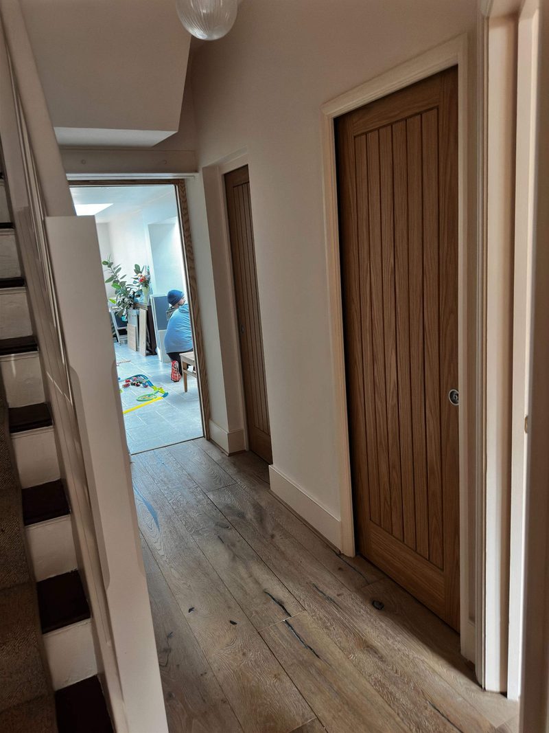 Solid oak internal doors fitted along an oak floored hallway