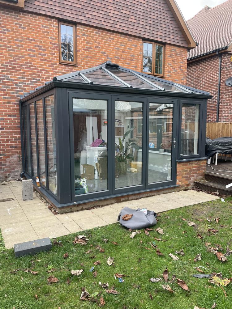 Black aluminium framed glass extension and orangery built by Dukes London on a Ruislip HA4 property — full-height glazing with lantern roof
