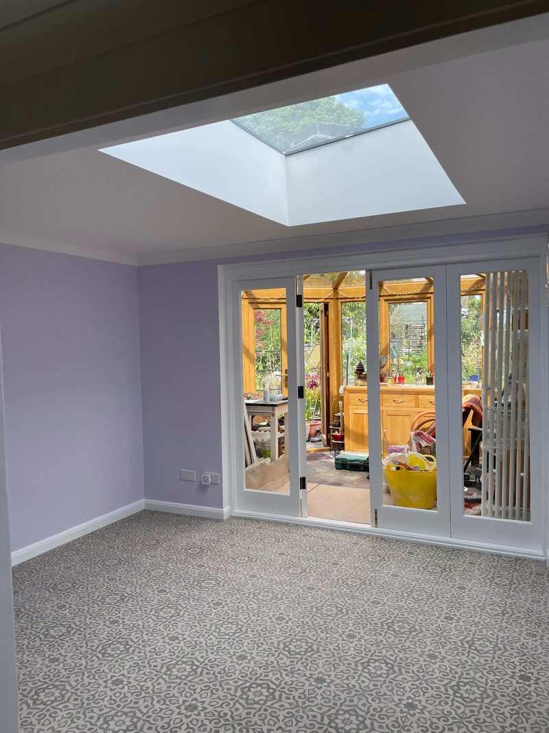 Flat rooflight skylight installed above a kitchen-diner with bifold doors to the garden