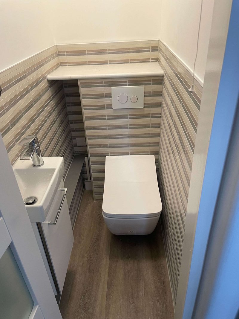 Compact downstairs cloakroom with wall-hung Toto WC and striped tiling